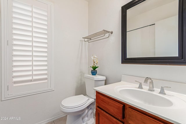 bathroom featuring tile patterned floors, vanity, and toilet