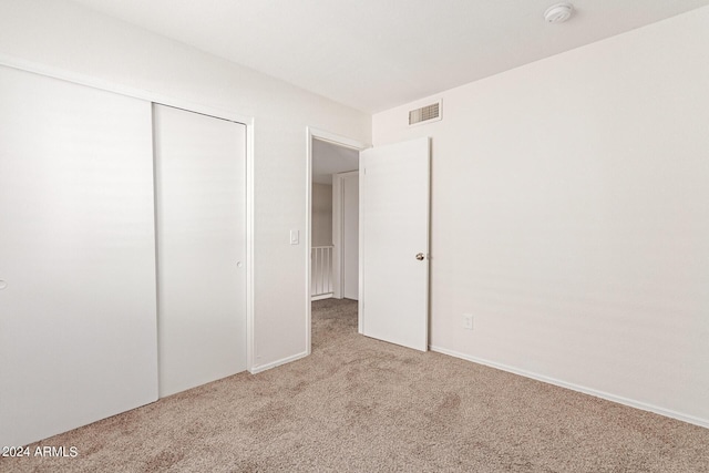 unfurnished bedroom featuring a closet and carpet