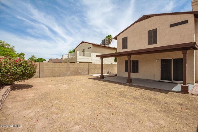 rear view of property with a patio area and cooling unit