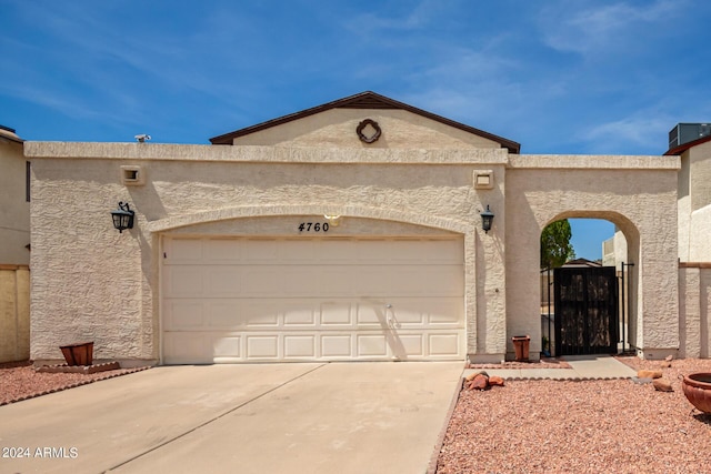 4760 W Wahalla Ln, Glendale, AZ 85308 - view of front of property with concrete driveway, a garage, a gate, and stucco siding