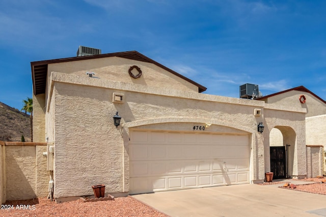 4760 W Wahalla Ln, Glendale, AZ 85308 - mediterranean / spanish-style house featuring driveway, an attached garage, central air condition unit, and stucco siding