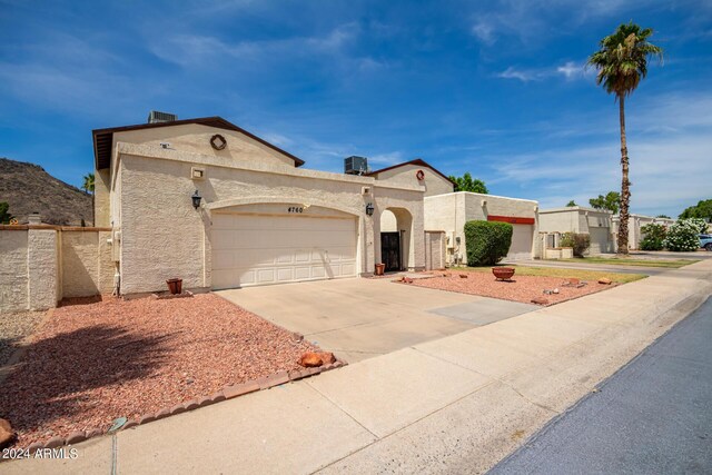 4760 W Wahalla Ln, Glendale, AZ 85308 - view of front of house featuring concrete driveway, an attached garage, and stucco siding