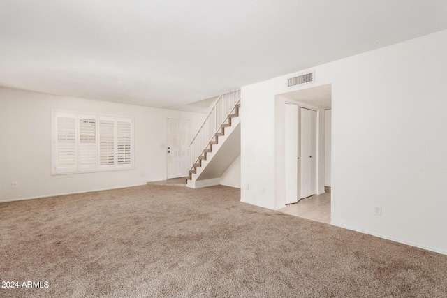 4760 W Wahalla Ln, Glendale, AZ 85308 - unfurnished living room featuring light carpet, stairway, and baseboards