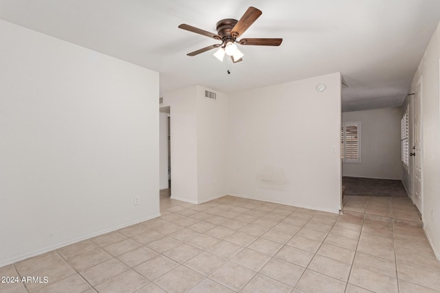 unfurnished room with light tile patterned floors and ceiling fan