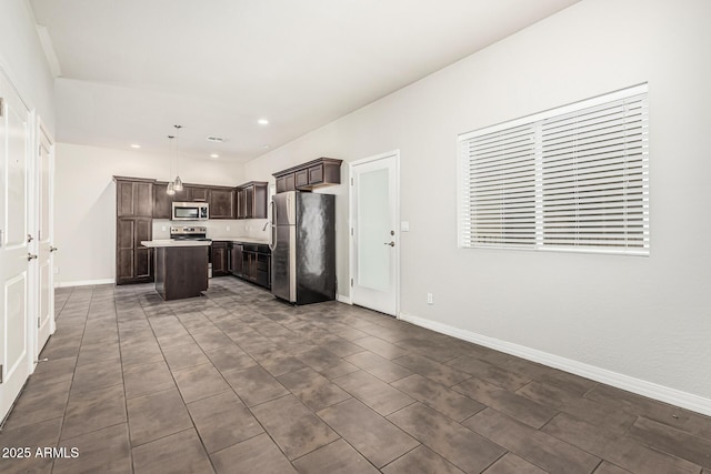 2000 N 36th St Unit 17, Phoenix, AZ 85008 - kitchen featuring stainless steel appliances, a center island, dark brown cabinets, light countertops, and hanging light fixtures