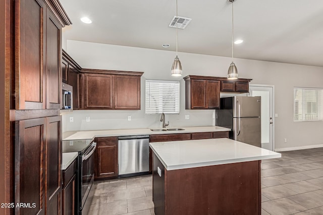 2000 N 36th St Unit 17, Phoenix, AZ 85008 - kitchen featuring appliances with stainless steel finishes, light tile patterned floors, light countertops, a kitchen island, and recessed lighting