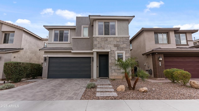 view of front facade featuring stone siding, stucco siding, decorative driveway, and a garage