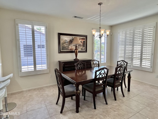 dining room featuring a notable chandelier and light tile patterned floors