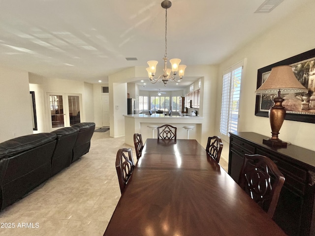 dining space with a notable chandelier