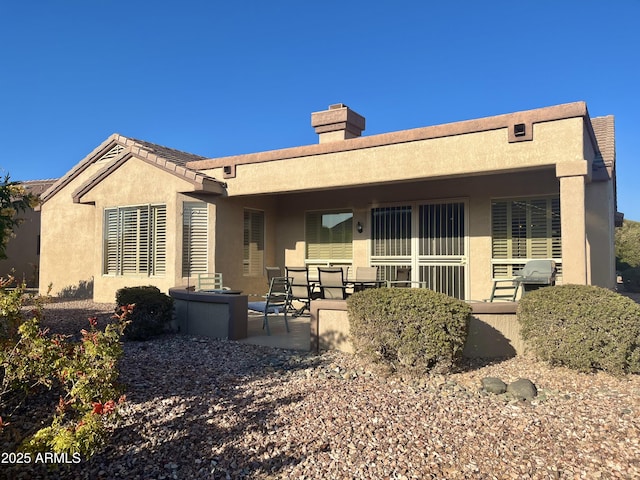 rear view of house featuring a patio