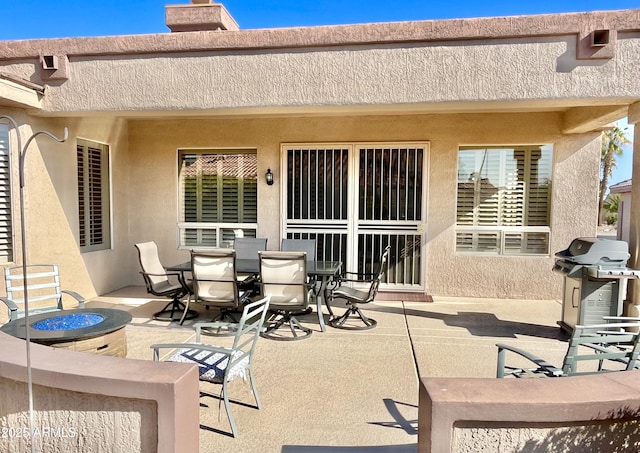 view of patio / terrace with grilling area and a fire pit