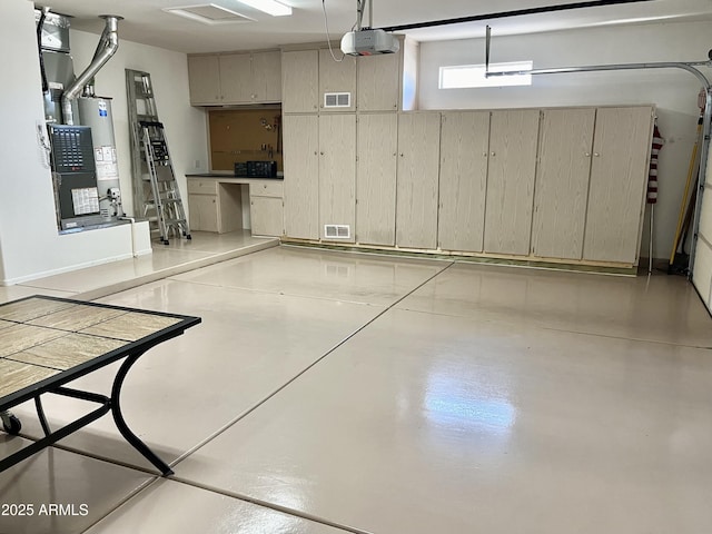 garage featuring a garage door opener and water heater