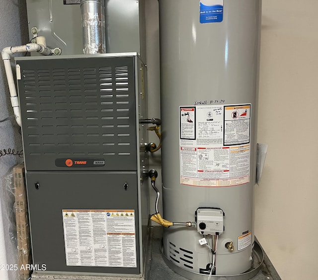 utility room with heating unit and water heater