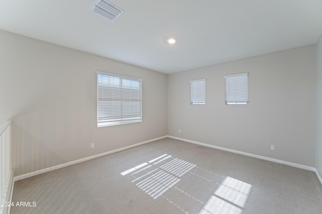 empty room featuring light colored carpet