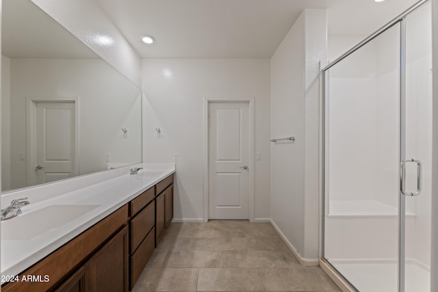 bathroom featuring vanity, tile patterned floors, and a shower with door