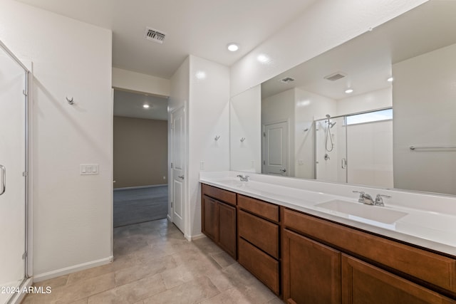 bathroom featuring vanity and a shower with shower door