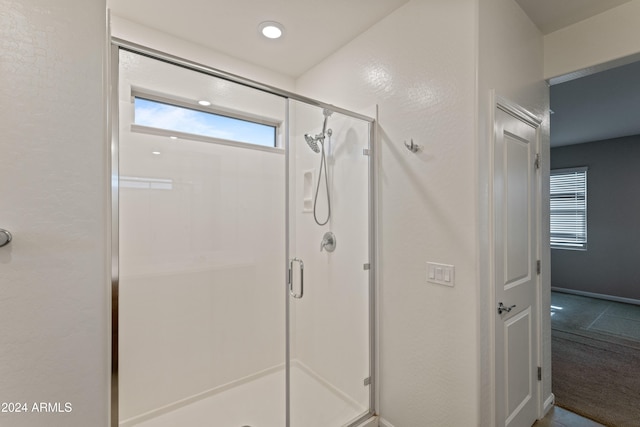 bathroom featuring tile patterned floors and an enclosed shower