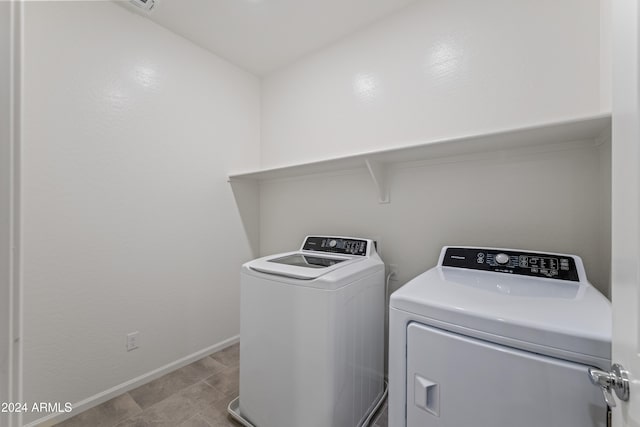 clothes washing area with separate washer and dryer