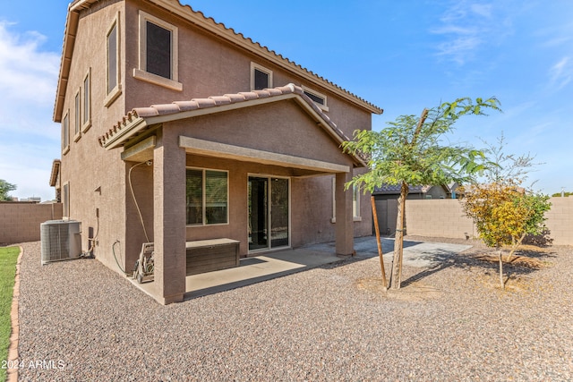 rear view of property featuring central AC unit and a patio area