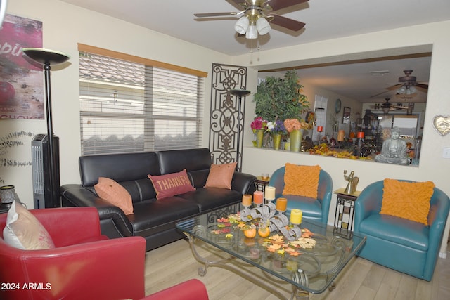 living room featuring ceiling fan and light wood-type flooring