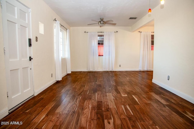 spare room featuring dark hardwood / wood-style floors and ceiling fan