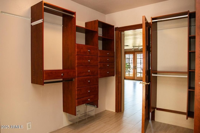 spacious closet featuring french doors