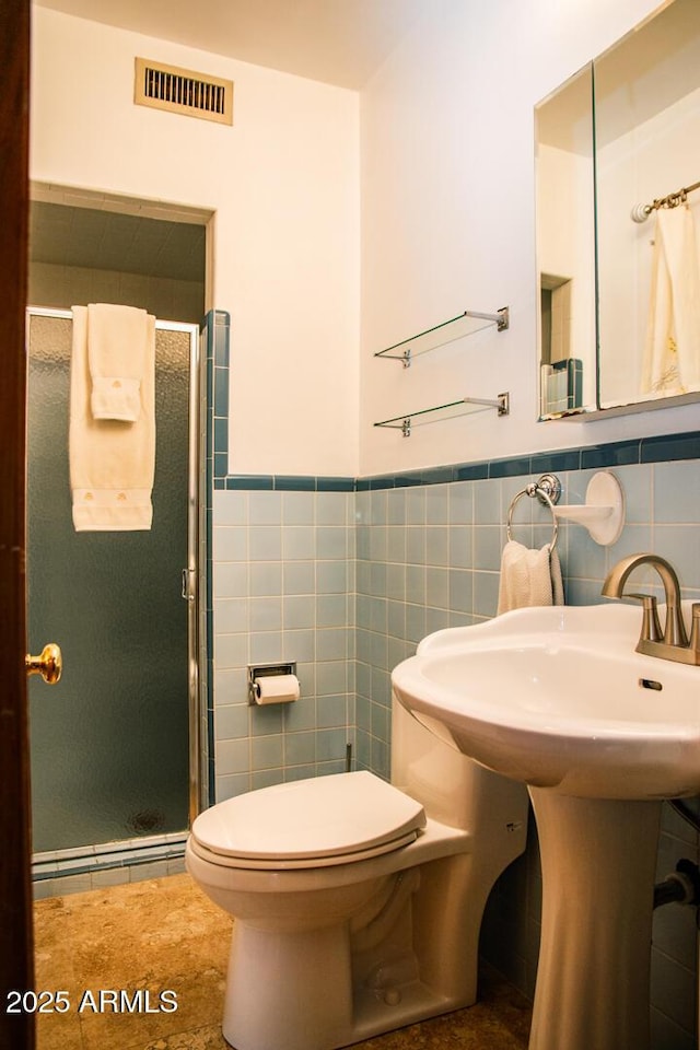 bathroom featuring a baseboard heating unit, tile walls, sink, toilet, and walk in shower