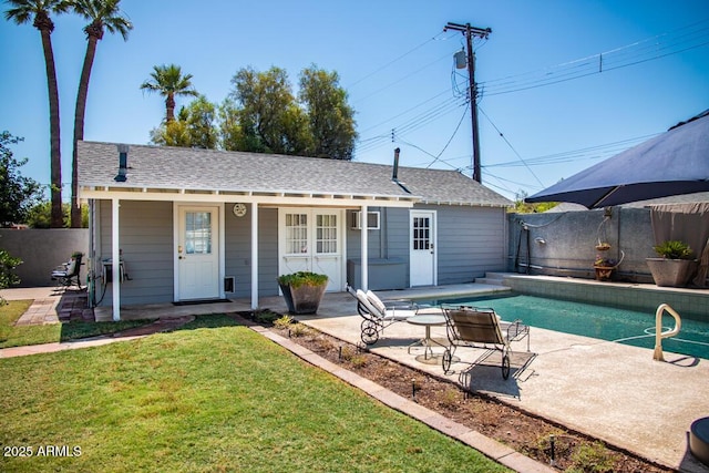 exterior space with a yard, an outdoor structure, and a patio