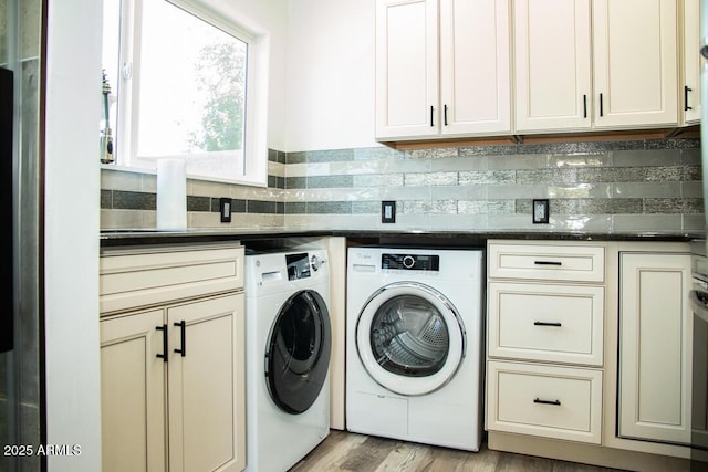 washroom featuring cabinets, independent washer and dryer, and light wood-type flooring