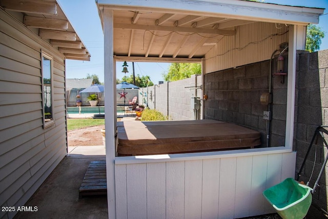 view of patio / terrace with a covered hot tub