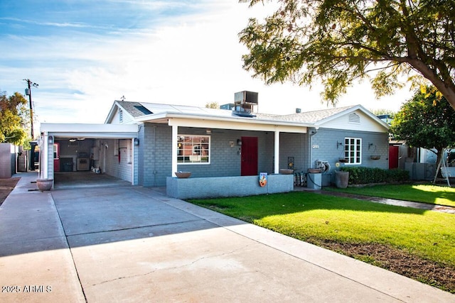 single story home with a garage, a front yard, and central air condition unit