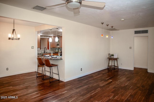 living room with ceiling fan, sink, and dark hardwood / wood-style flooring