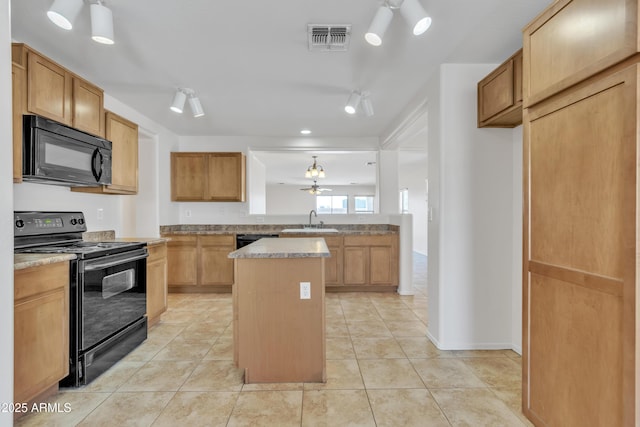 kitchen featuring visible vents, light tile patterned floors, a sink, black appliances, and a kitchen island