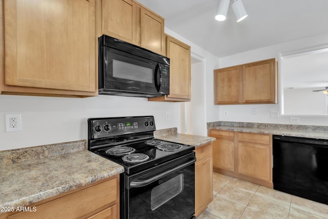 kitchen with light tile patterned flooring, light brown cabinetry, and black appliances
