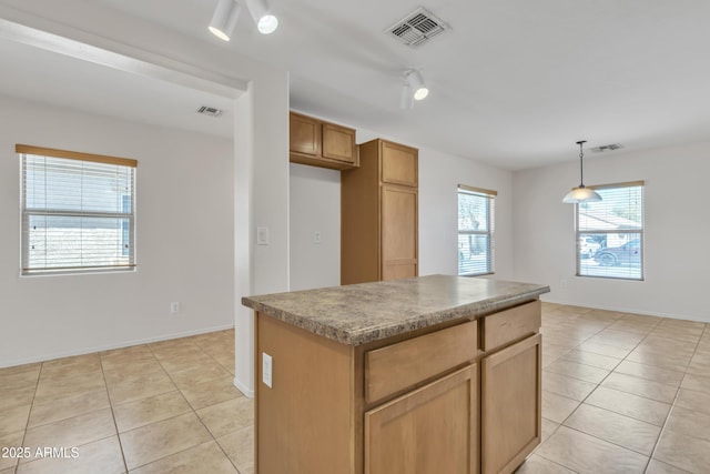 kitchen featuring visible vents, decorative light fixtures, and light tile patterned flooring
