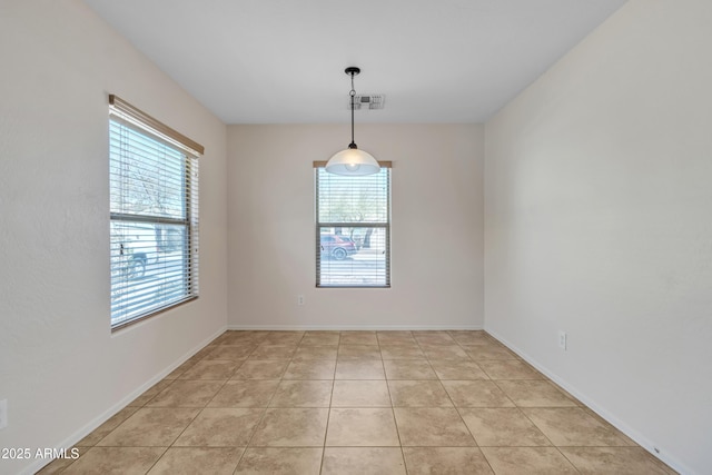 spare room with light tile patterned floors, baseboards, and visible vents
