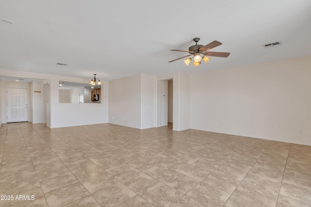 unfurnished living room with visible vents, light tile patterned floors, and ceiling fan with notable chandelier