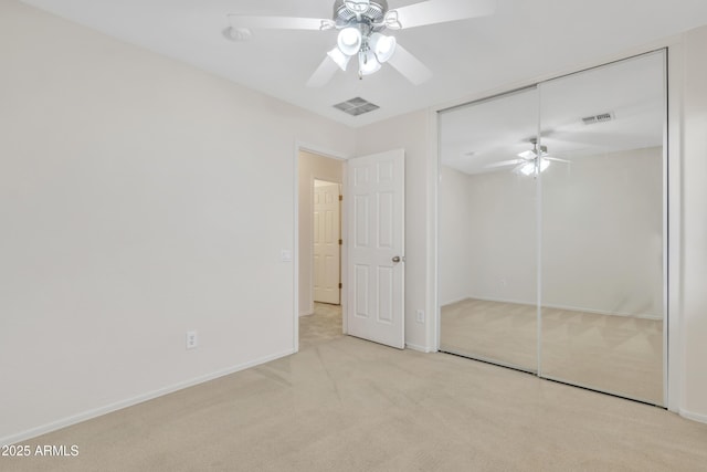 unfurnished bedroom with ceiling fan, baseboards, carpet, and visible vents