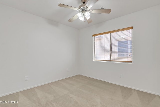 unfurnished room featuring baseboards, a ceiling fan, and light colored carpet