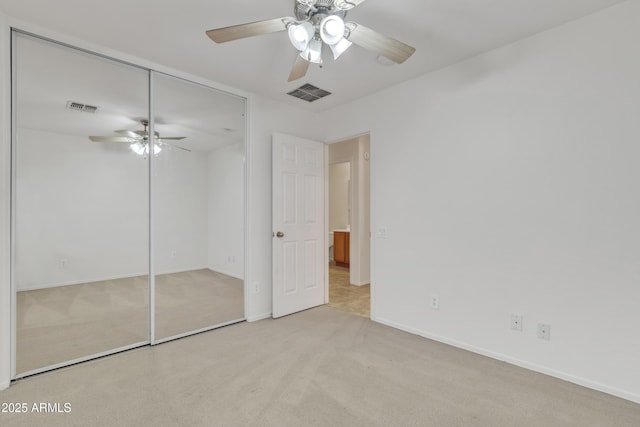 unfurnished bedroom featuring visible vents, ceiling fan, a closet, and carpet floors