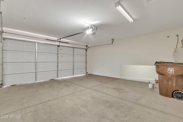 garage featuring water heater and a garage door opener