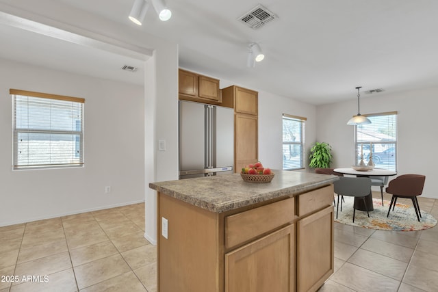kitchen featuring visible vents, high quality fridge, and light tile patterned flooring