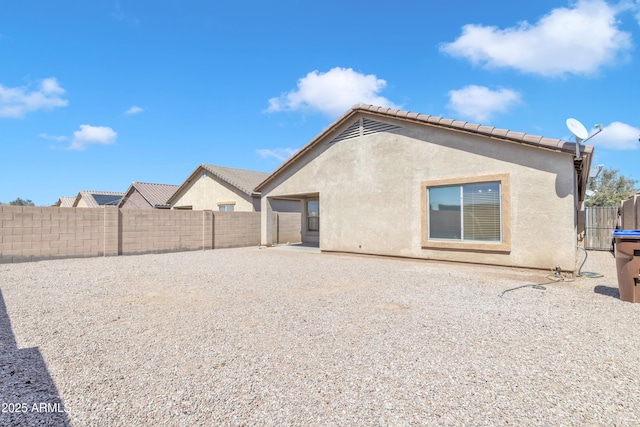 back of property featuring a patio area, stucco siding, and a fenced backyard