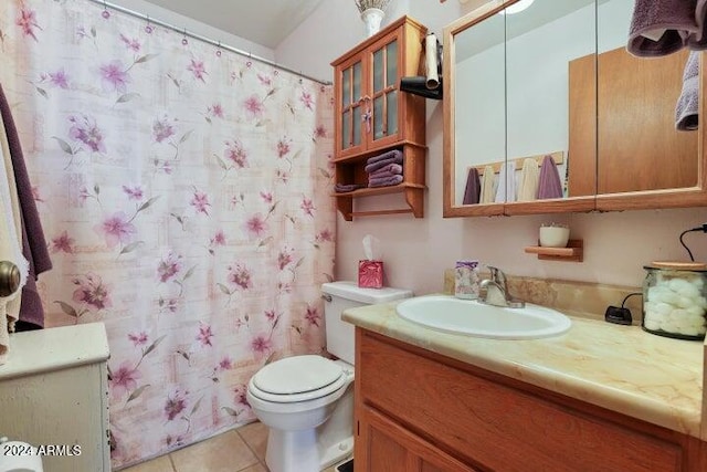 bathroom featuring tile patterned floors, vanity, and toilet