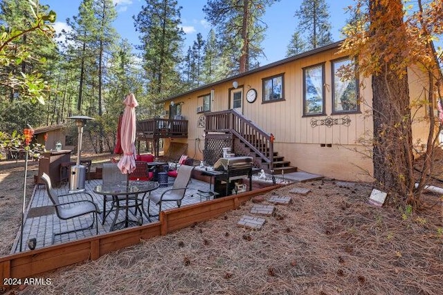 back of property with a patio area and a deck