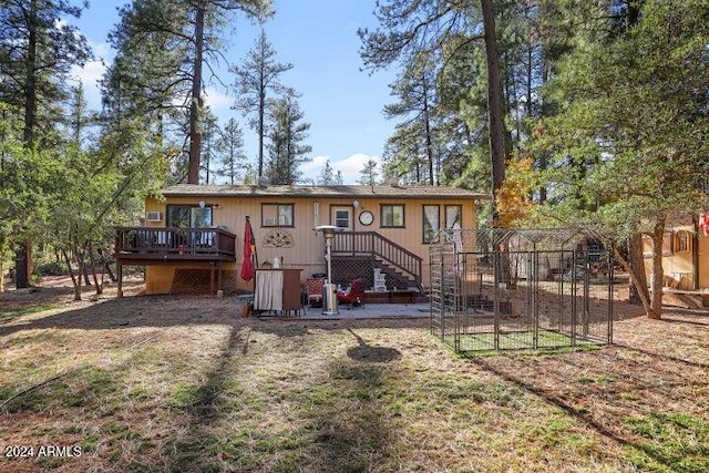 rear view of house with a wooden deck