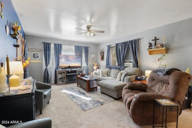 living room with carpet flooring, a textured ceiling, and ceiling fan