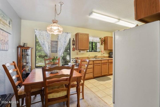 tiled dining room featuring sink