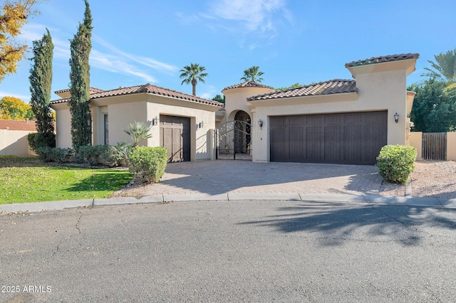 mediterranean / spanish home featuring a garage