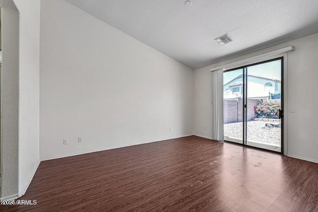 empty room with dark hardwood / wood-style floors